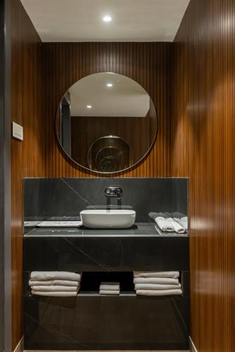 a bathroom with a sink and a mirror at Assembly By The Democracy in Nashik