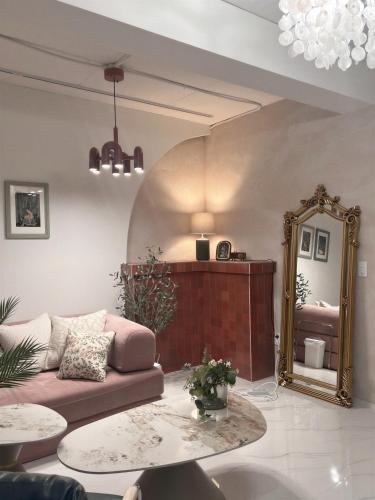 a living room with a couch and a mirror at Jeonpo Cafe Street Near Seomyeon Entire House 2 Floors 7 Guests in Busan