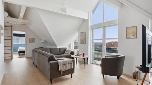 a living room with a couch and chairs and a tv at Villavilla 148 - Ebeltoft, Østjylland in Ebeltoft