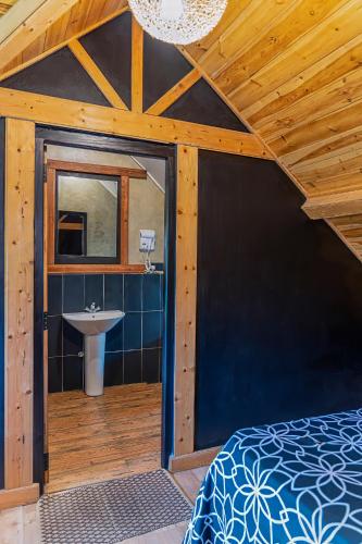 a bathroom with a bed and a sink in a room at The Cottage - Assure your Tickets for the Ella train journey in Ambawela