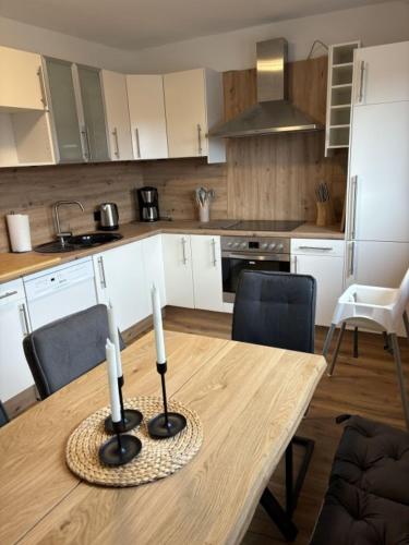 a kitchen with a table with two candles on it at Wurmbergblick Ferienwohnung in Braunlage