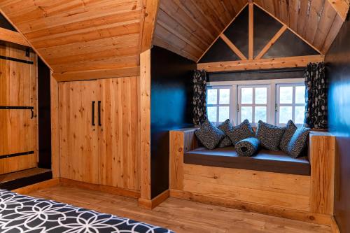 a bed in a room with a window at The Cottage - Assure your Tickets for the Ella train journey in Ambawela