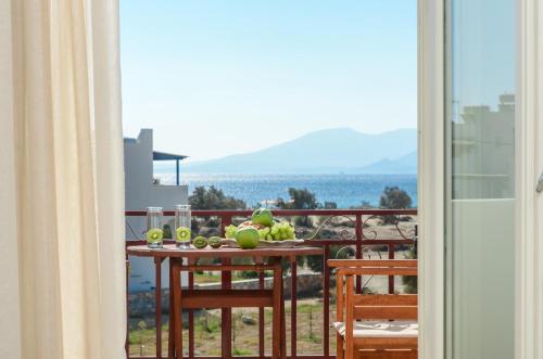 a table with fruit on top of a balcony at Perla Hotel in Agios Prokopios