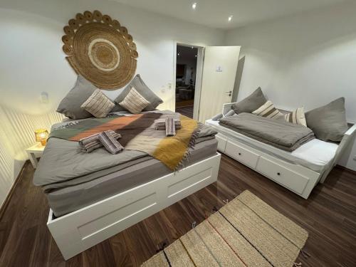 a bedroom with two beds and a mirror at BOHO Suite Tierra nähe Salzburg in Freilassing