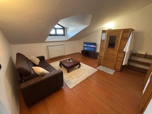 a living room with a couch and a table at Fusero1 relax vero borgata fusero 20 giaveno in Coazze