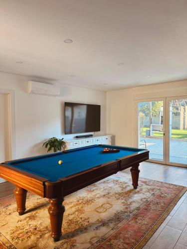 a pool table in a living room with at Villa Rosa in Melgaço