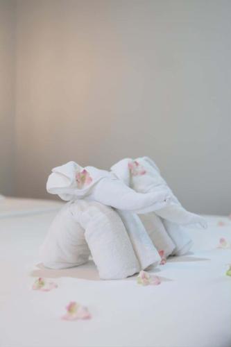 a group of three towels sitting on a table at Rungarun Residence in Ratchaburi