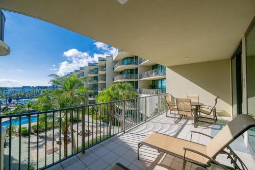 a balcony with chairs and a view of the ocean at Phoenix on the Bay 1320 in Orange Beach