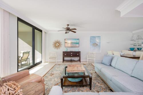 a living room with a couch and a table at Phoenix on the Bay 1320 in Orange Beach
