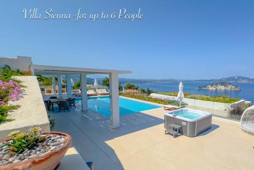 a view of a swimming pool with a tv on a patio at Villa Lamar Private Luxury Villa in Marathias