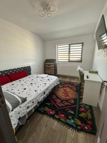 a bedroom with a bed and a rug at SkyView Lofts-Enjoy the view in Preajba