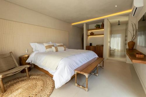 a bedroom with a large bed and a bench at Lahaina Hotel in Icaraí