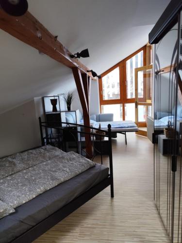 a bedroom with a bed and a table and windows at Boxenstop in Kleinlobming
