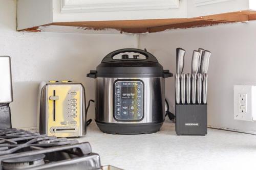 a slow cooker sitting on top of a kitchen counter at ComfiNook Cozy Suburb Stay Philly Airport Parking