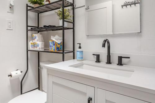 a white bathroom with a sink and a toilet at ComfiNook Cozy Suburb Stay Philly Airport Parking