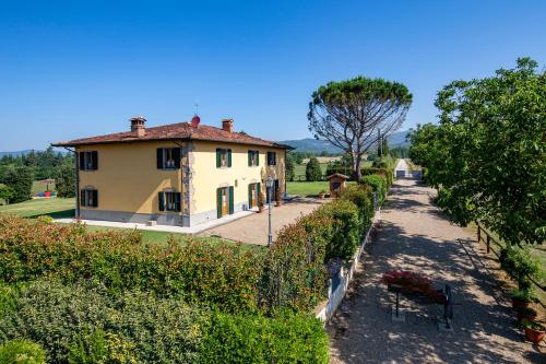 a view of a house with a fence at Villa Farmi by MMega in Bibbiena