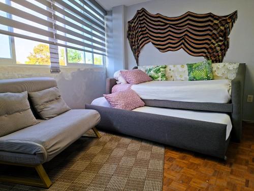 a living room with two beds and a couch at Mexicaníssima 4BR, 4 to 11 guests in Coyoacán in Mexico City