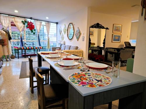 a kitchen with a table with plates on it at Mexicaníssima 4BR, 4 to 11 guests in Coyoacán in Mexico City