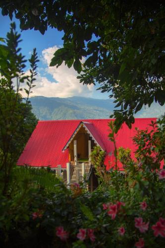 a red roofed house with a red roof at Open view home stay in Mangpu
