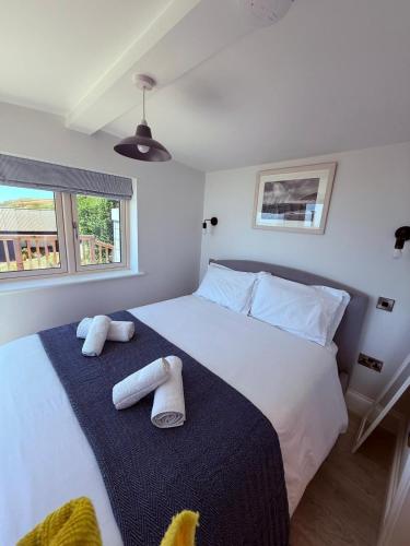 a bedroom with a large bed with towels on it at Recently renovated beach shack with a view in Antony