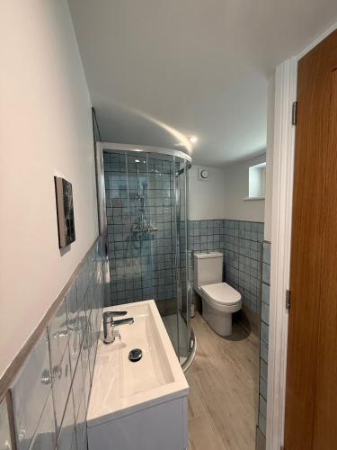 a bathroom with a sink and a toilet at Recently renovated beach shack with a view in Antony