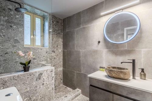 a bathroom with a sink and a mirror at Villa Palataki II in Kardamyli