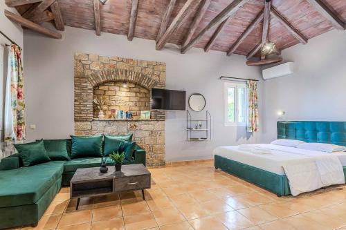 a living room with a bed and a couch at Villa Palataki I in Kardamyli