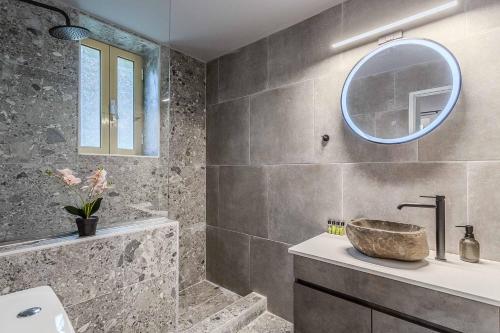 a bathroom with a sink and a mirror at Villa Palataki I in Kardamyli
