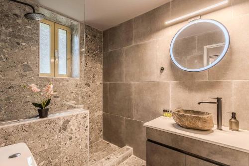 a bathroom with a sink and a mirror at Villa Palataki III in Kardamyli