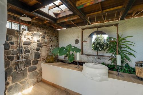 a bathroom with a large tub and a mirror at El Sueño de Mamá in Tegueste