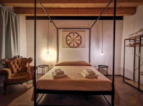 a bedroom with a bed and a clock on the wall at Le Dimore di San Nicola in Favara