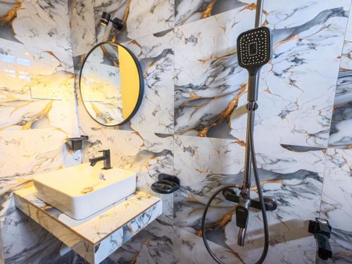 a bathroom with a sink and a mirror at Omar Villa in Bentota