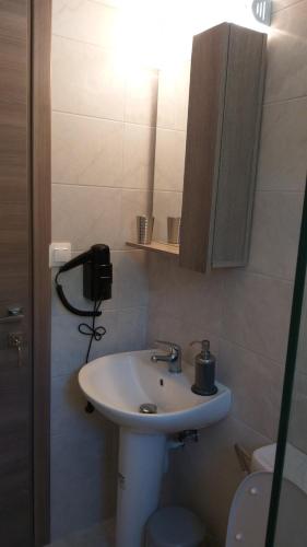 a bathroom with a white sink and a toilet at Villa Bloom in Achladies