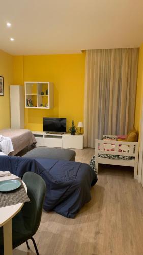 a bedroom with two beds and a flat screen tv at Appartamento Meriggio in Gabicce Mare