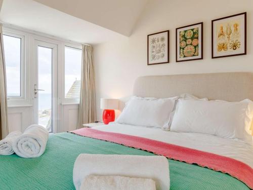 a bedroom with a large bed with towels on it at 4 Bed in Bridport oc-dc083 in West Bay