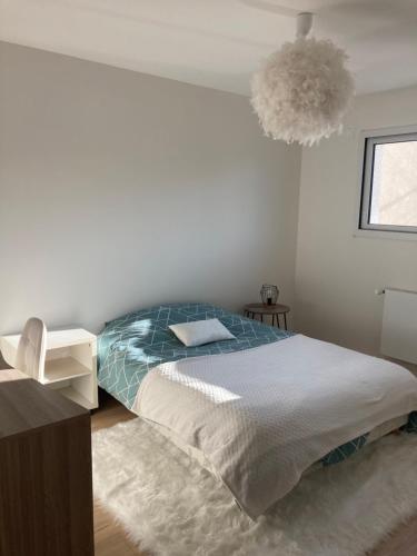 a bedroom with a bed and a pendant light at Cozy M&O House in Le Mans