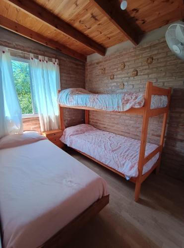 a bedroom with two bunk beds and a window at La Posada De Vito in Córdoba