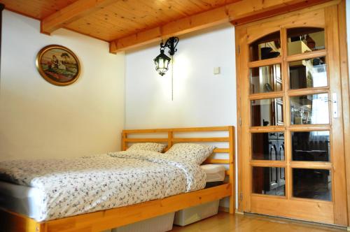 een slaapkamer met een bed en een glazen deur bij Traditional Slovak Apartment in Bratislava