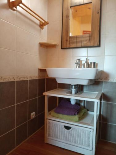 a bathroom with a sink and a mirror at Noyers du Soleil, Chambre d'hôte avec petit déjeuner à proximité de Gap in La Bâtie-Vieille