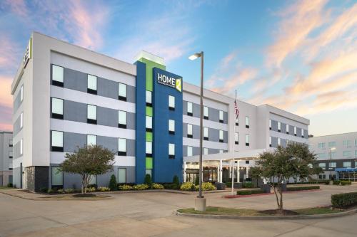 an office building with a hud sign on it at Home2 Suites By Hilton Lake Charles in Lake Charles