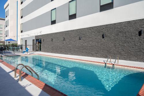 a swimming pool in front of a building at Home2 Suites By Hilton Lake Charles in Lake Charles
