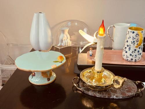 a table with a candle and other items on it at Family Home with fast trains to London Bridge, Victoria, Gatwick and Wimbledon in Croydon