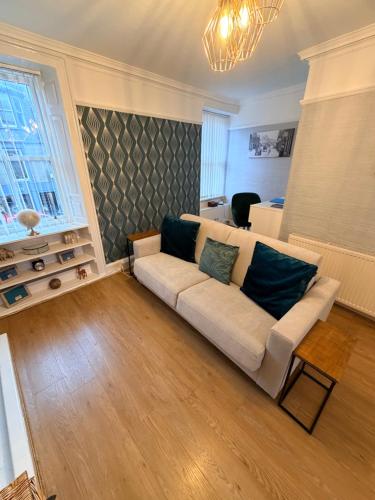 a living room with a couch and a table at Harris Apartment in Montrose