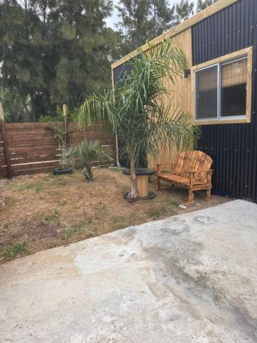 a wooden bench sitting next to a wooden fence at L a N e g r a in Barra de Portezuelo