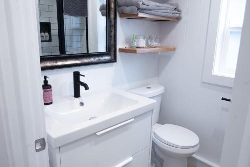 a white bathroom with a sink and a toilet at Cozy 2 Bedroom Cabin in Sunshine Valley