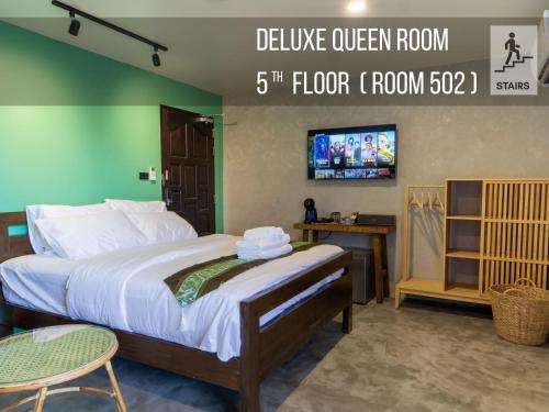 a bedroom with a bed with a tv on the wall at Lo-Ha Guest house, Contactless Check-in in Bangkok