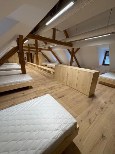 a room with several mattresses on a wooden floor at Das Fränkische Reichenbach in Reichenbach