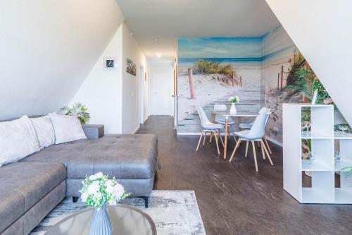 a living room with a couch and a table at Ferienwohnung Tina OG in Boltenhagen