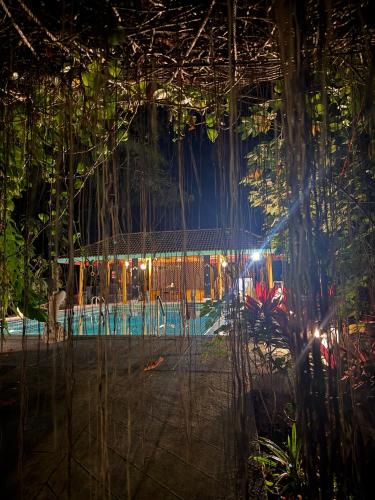 a room with a fence and trees at night at Baan Rim Tarn B&B in Takua Pa