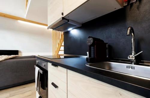 a kitchen with a sink and a counter top at Chalés Luna In Rio Chalé Rio in Ponte da Barca